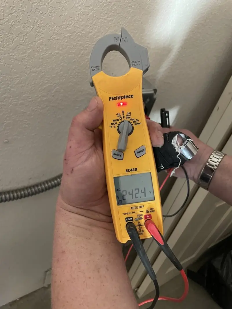 Voltage testing with clamp meter during Electrical Installation Services in Clarion